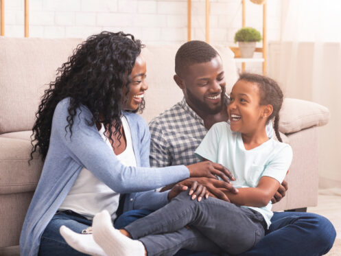 A cozy Texas home interior with warm lighting, comfortable seating, and a happy family.