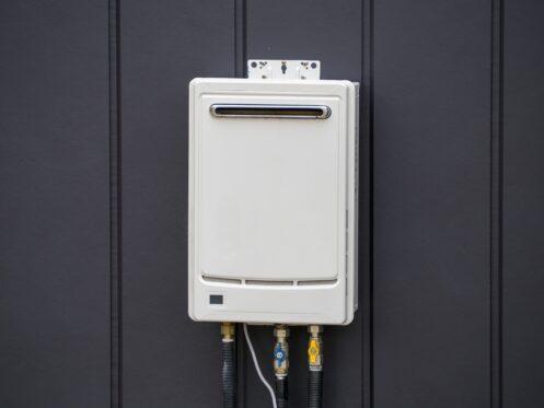 A Tankless Water Heater in a suburban Texas home, surrounded by a black wall.