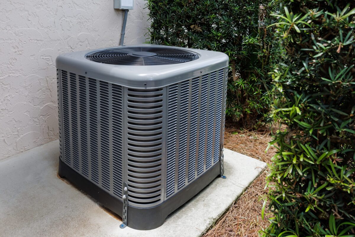 An Air Handler Unit Leaking Water, outside a modern home.