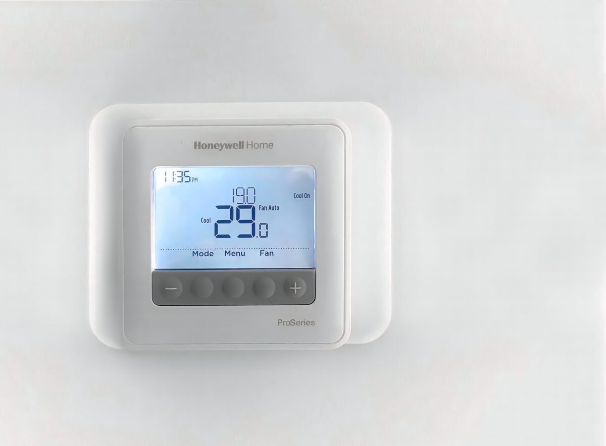 A modern Honeywell thermostat on the wall of a cozy suburban living room in Austin, Texas.