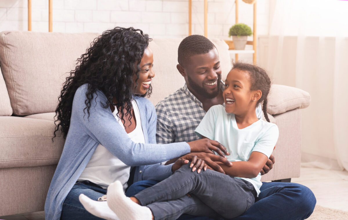 A cozy Texas home interior with warm lighting, comfortable seating, and a happy family.