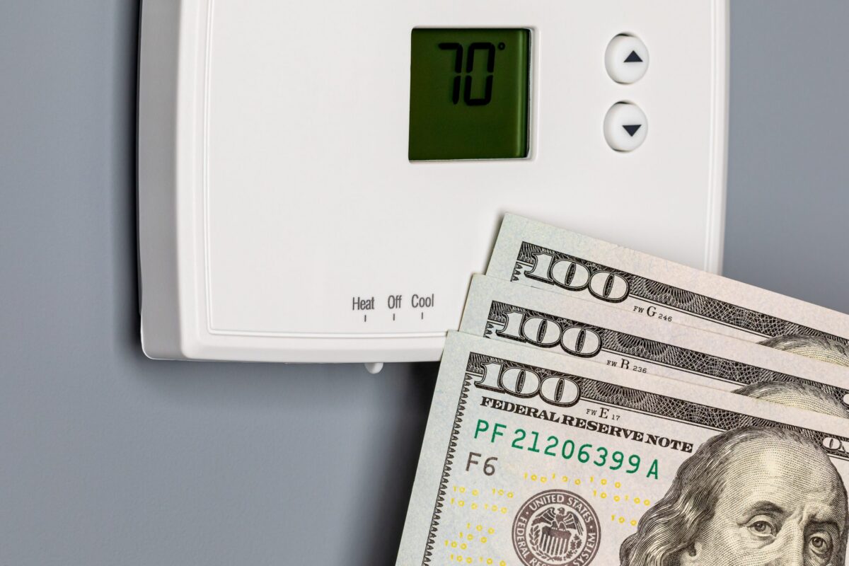 A thermostat in a Texas home that has the heat turned on showing $300 for Geothermal Heat Pump Cost.