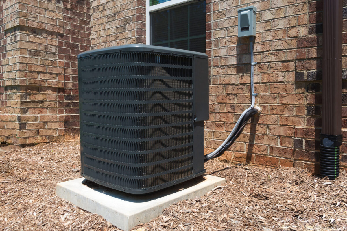 An ac unit leaking water, outside a cozy home in Texas.