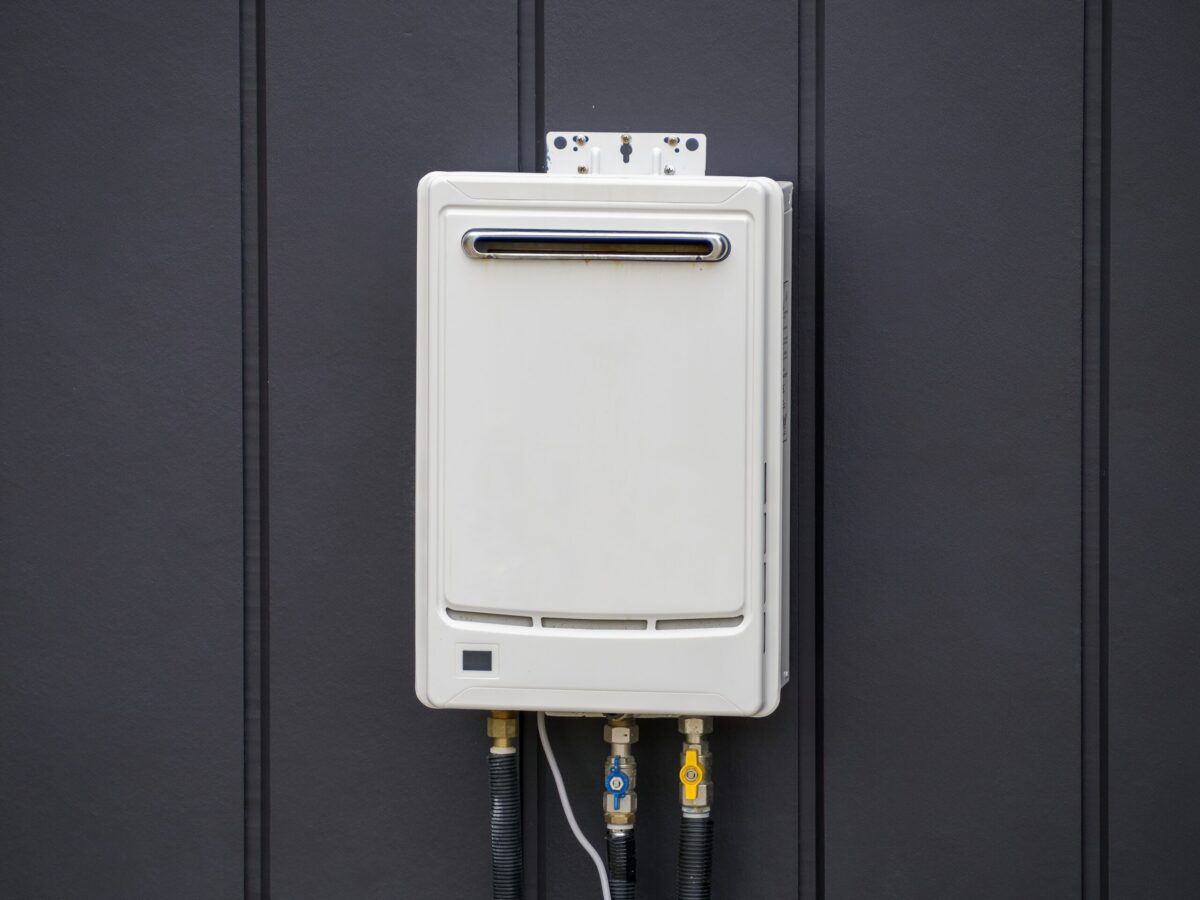 A Tankless Water Heater in a suburban Texas home, surrounded by a black wall.